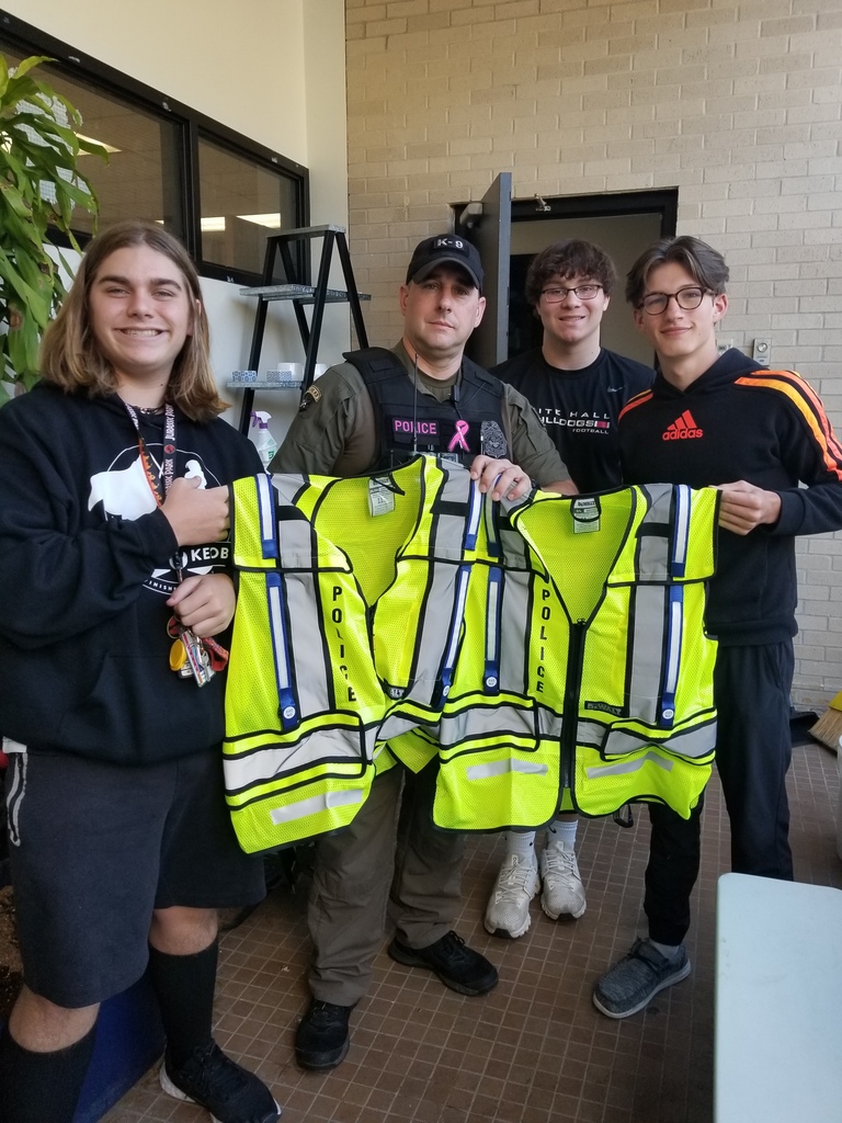 Beta Club Members Will Young .Aiden Jenkins, and Elijah Reinking present SRO Officer Harley Herron with safety vests 