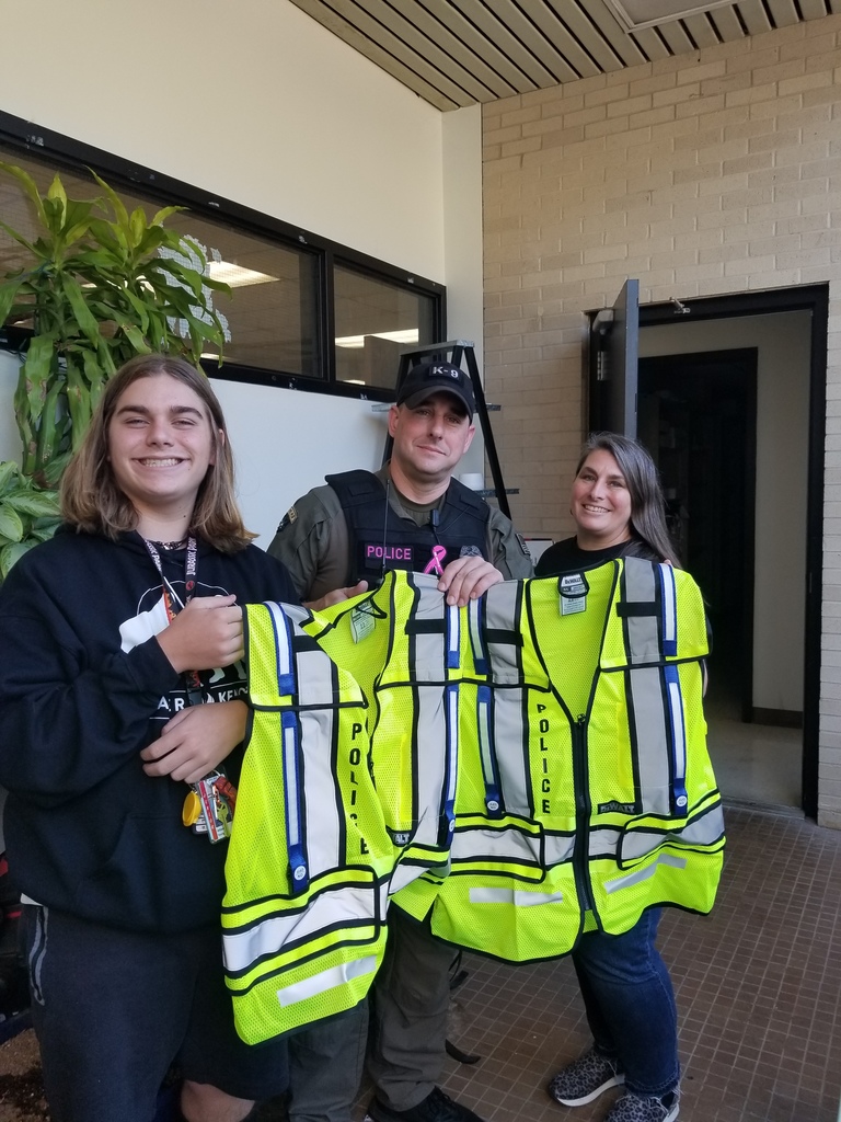 Beta Club Sponsor, Christy Henslee,  and Vice President,  Will Young,  present Officer Harley Herron with the vests 